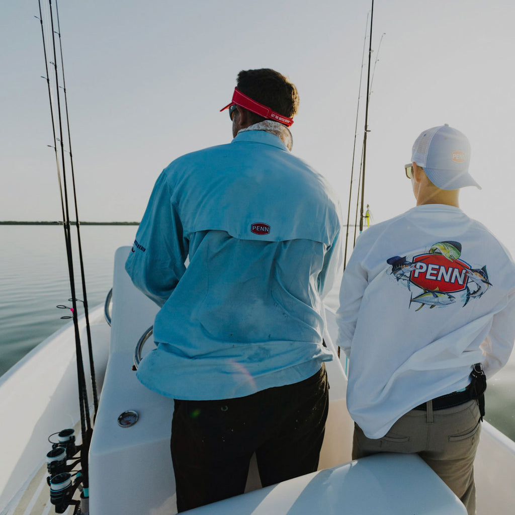 2 men on a boat with fishing gear