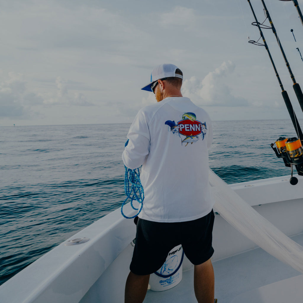 Man on a boat in a PENN shirt