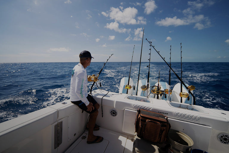 Guy fishing off boat in the ocean